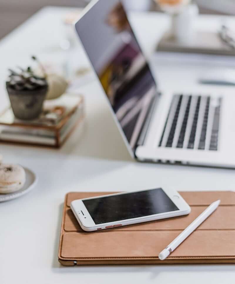 Workstation with iPad and iPhone with laptop in background